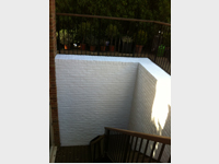 Bare bricks painted in white masonry paint